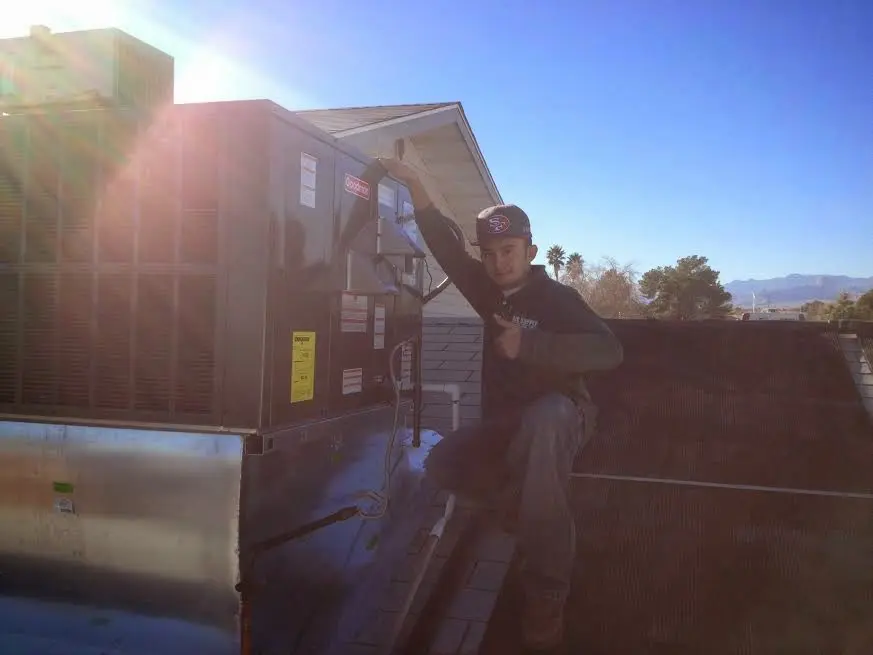 HVAC technician performing Boiler Repair on a rooftop unit in Santa Clarita
